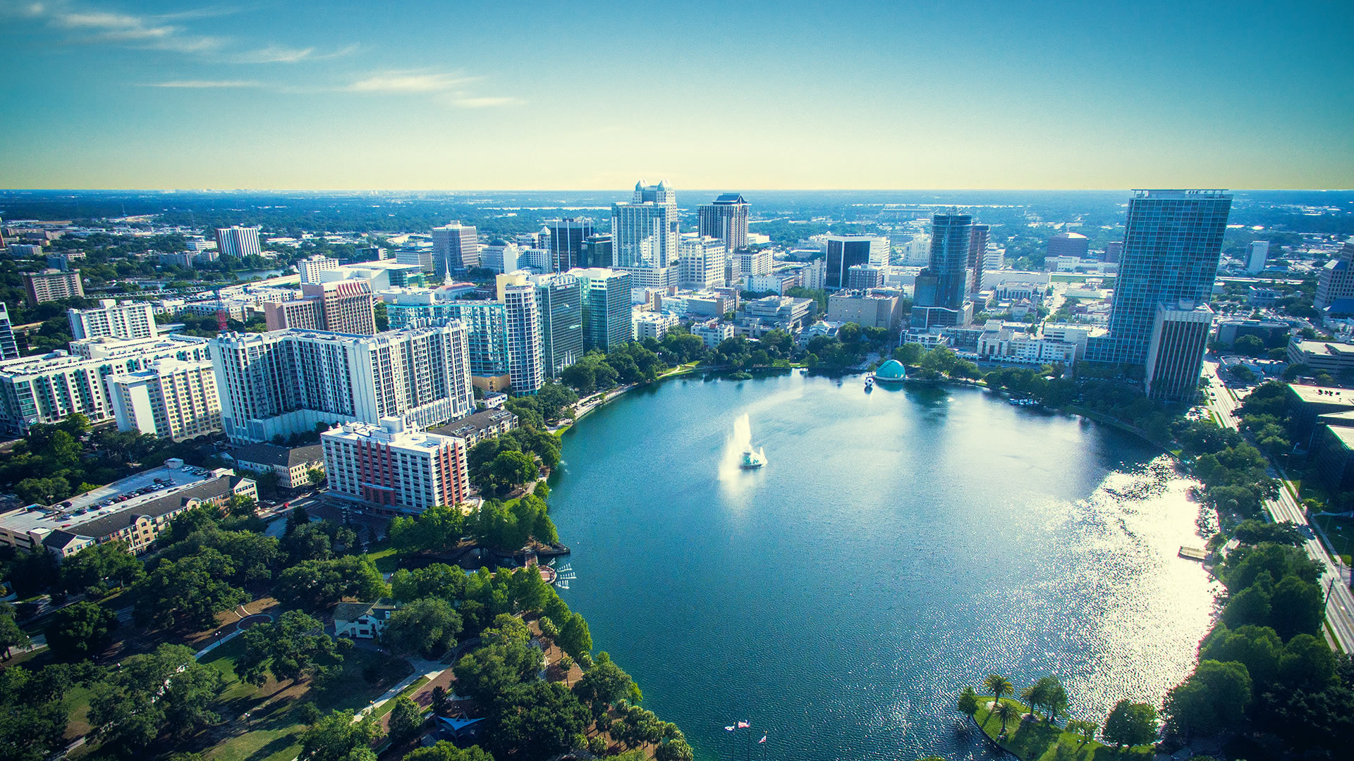 Aerial view of downtown Orlando skyline overlooking Lake Eola with the fountain
