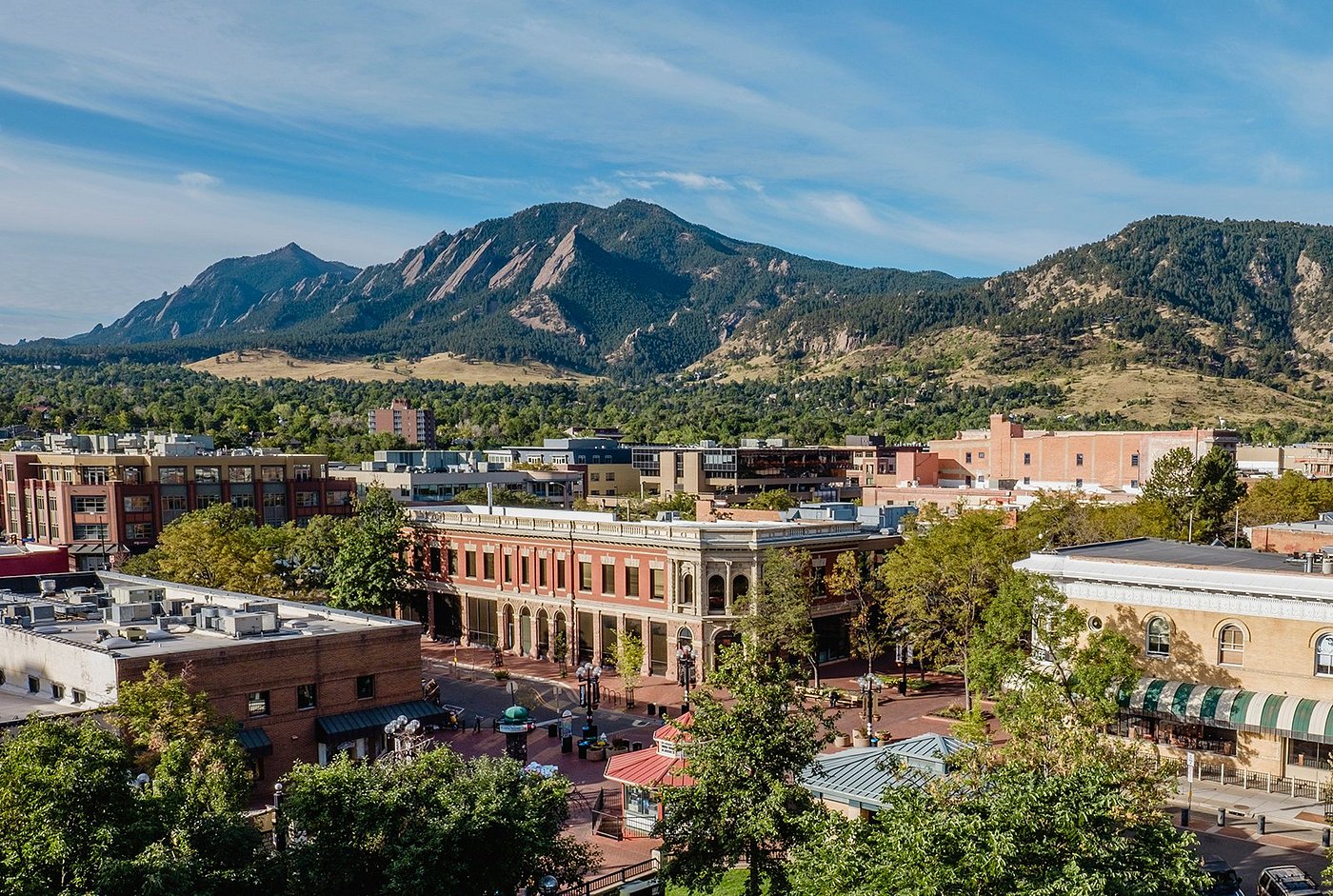 Downtown Boulder buildings with the Flatirons rising behind