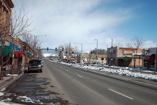 Downtown Main Street in Montrose, Colorado in winter with snow along the curbs