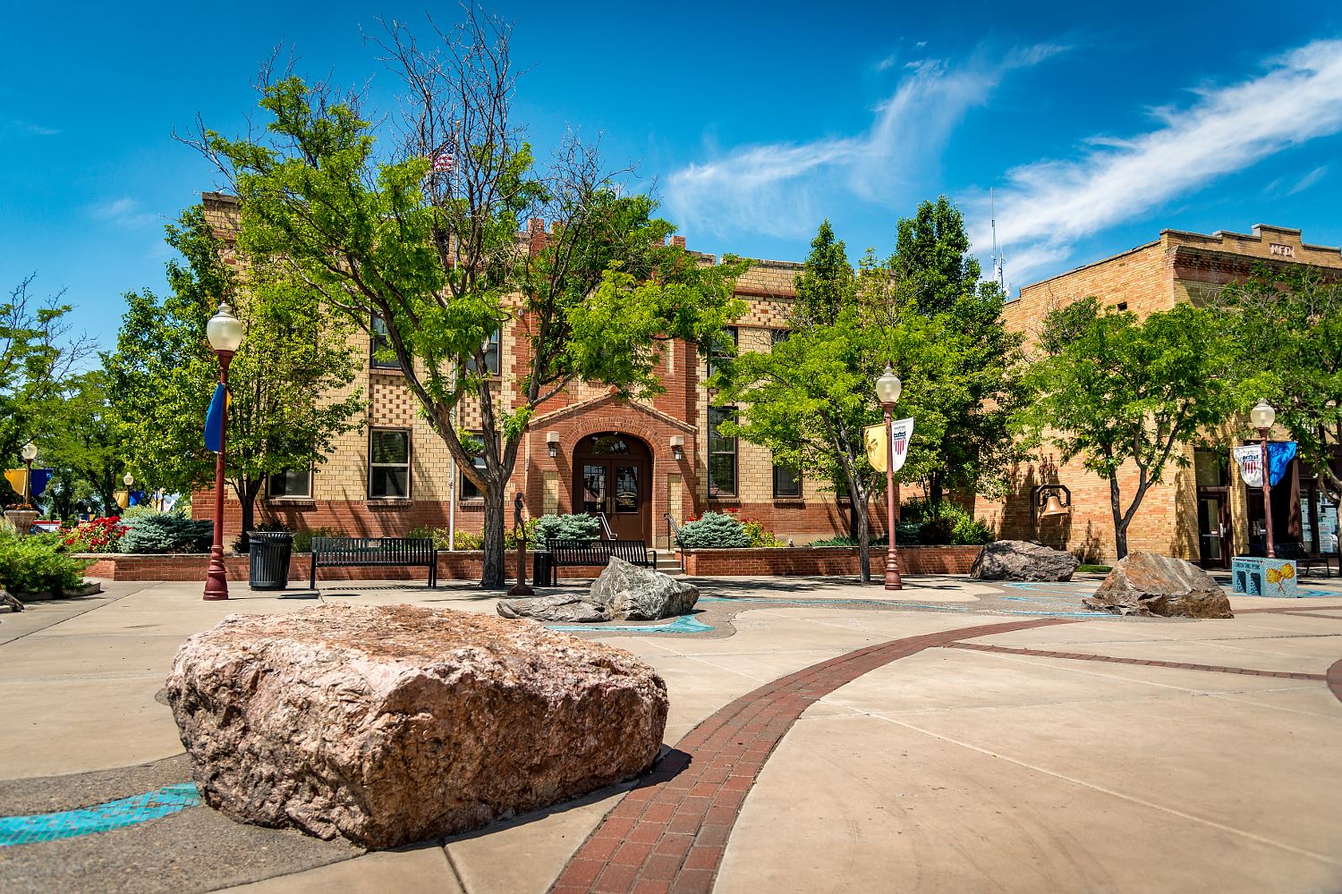 Historic brick civic plaza in downtown Montrose, Colorado with American flag flying