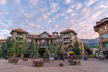 Mountain Village core plaza in Telluride at dusk with condos and shops