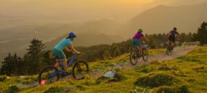 3 people riding mountain bikes on a mountain trail